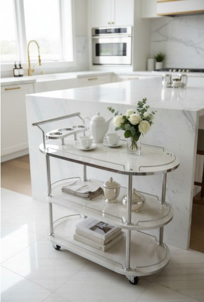 Modern kitchen with a marble-topped island and a rolling cart.