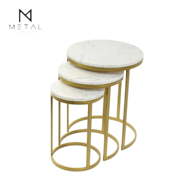 Set of three round marble top tables with gold metal bases on a white background