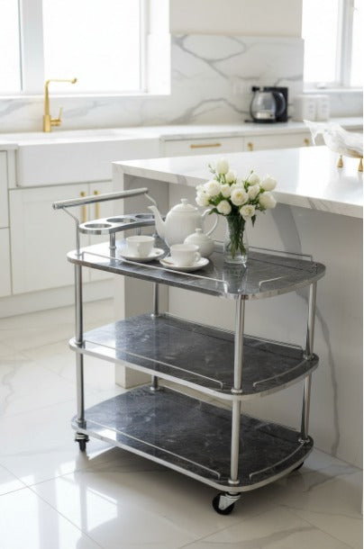Three-tiered serving cart with marble-like finish in a kitchen setting