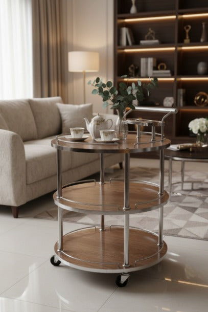 Three-tiered serving cart in a living room setting with decor items.